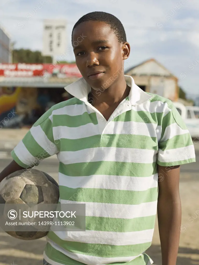 Teenage african boy with football