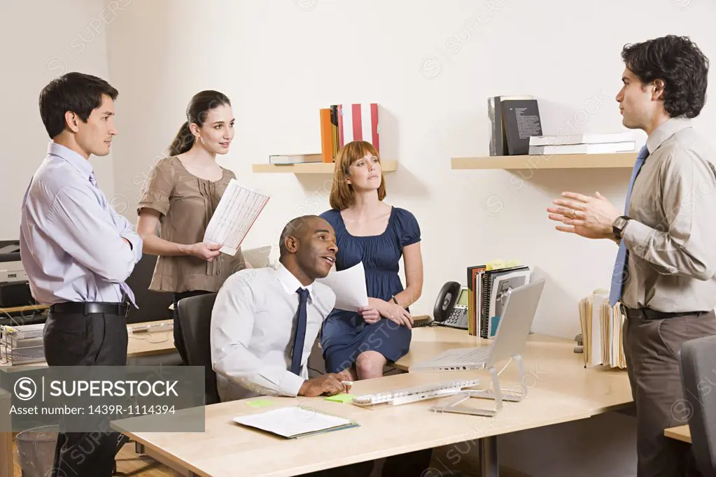 Five office workers in a meeting