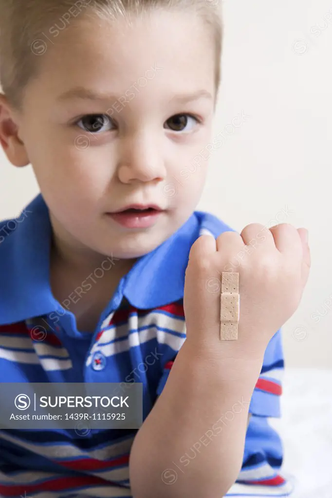 Boy with plaster on hand