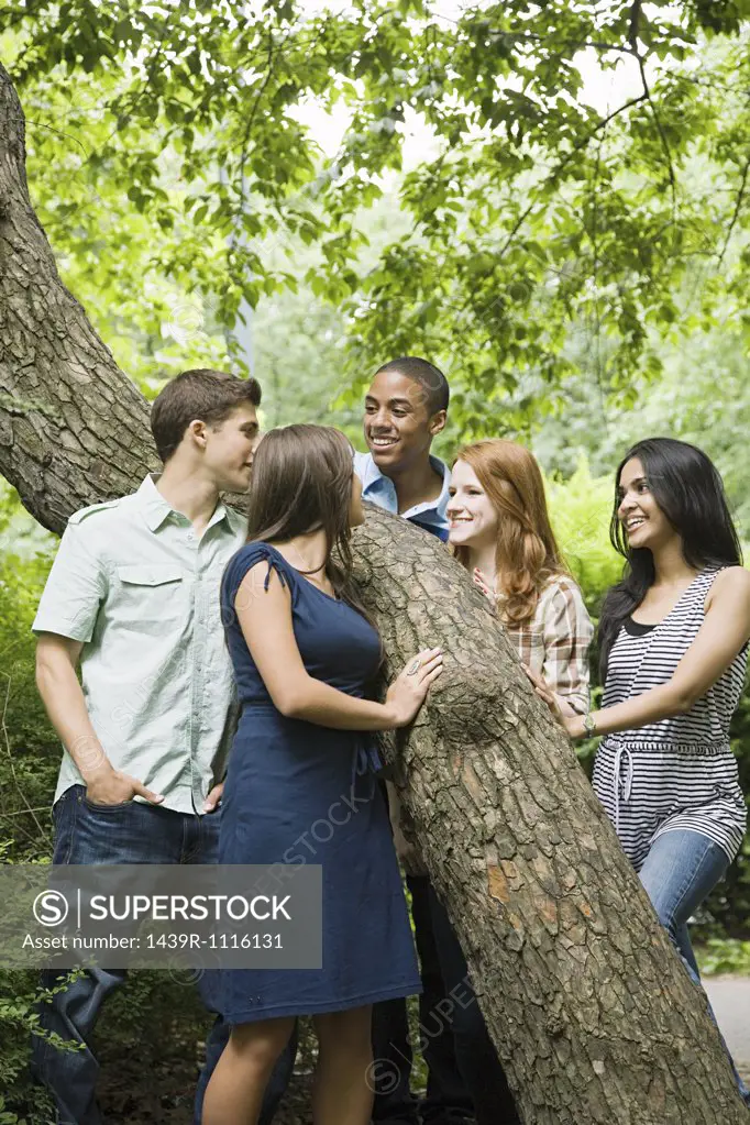 Five friends around a tree