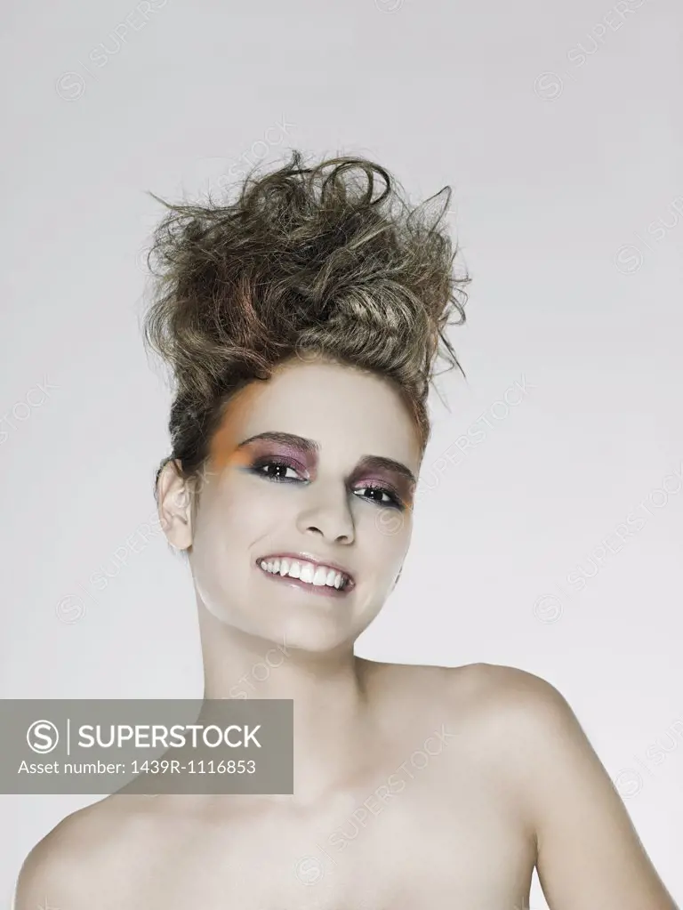 Young woman with hair up and bright makeup