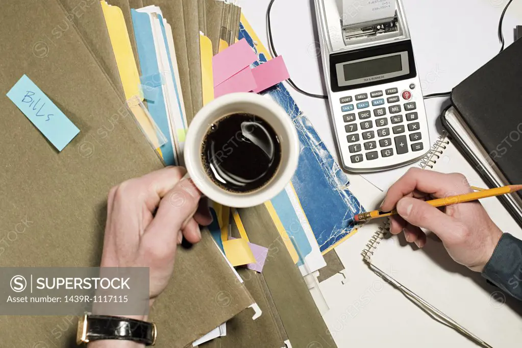 Person with coffee and files