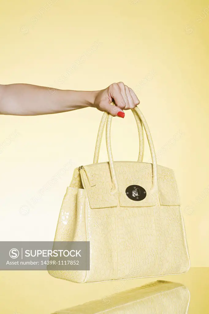 Woman holding yellow handbag