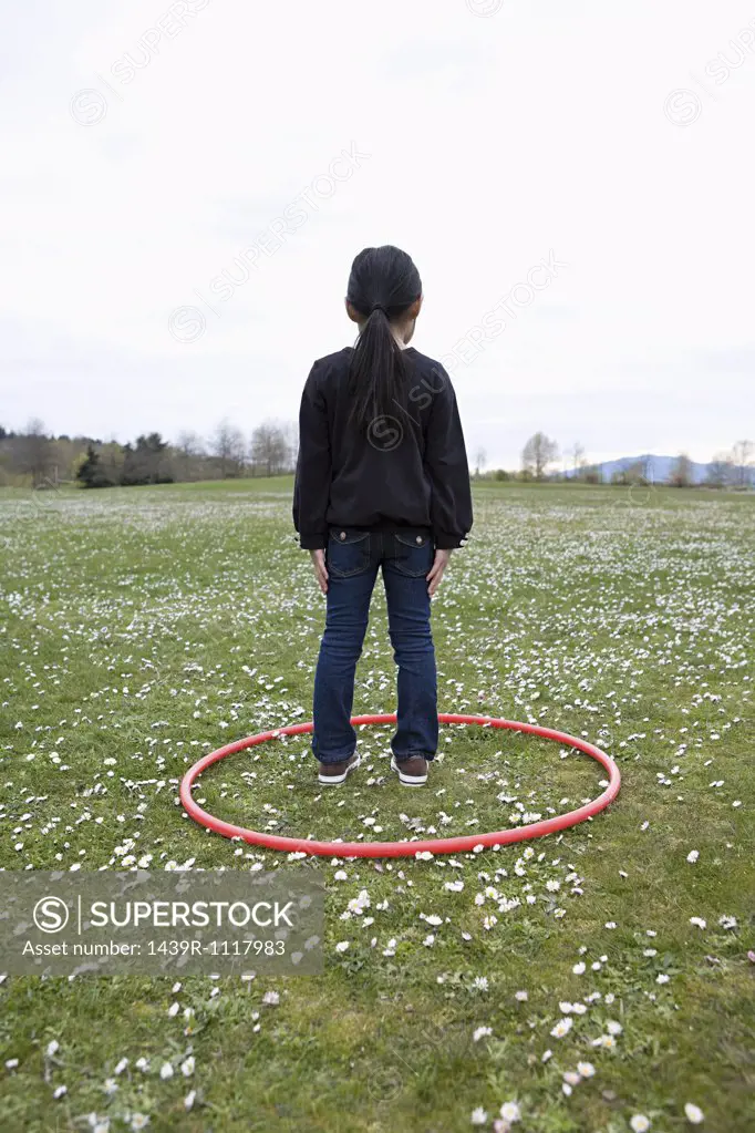 Girl standing in a hoop in a field