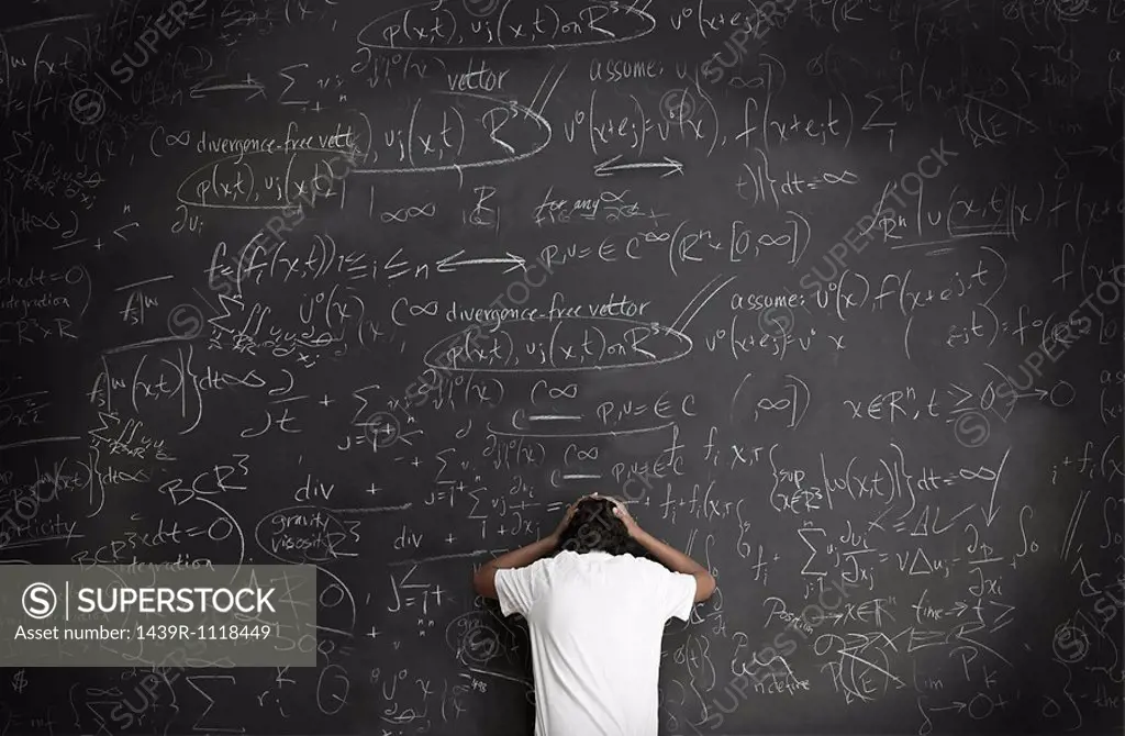 Boy with formulae on blackboard