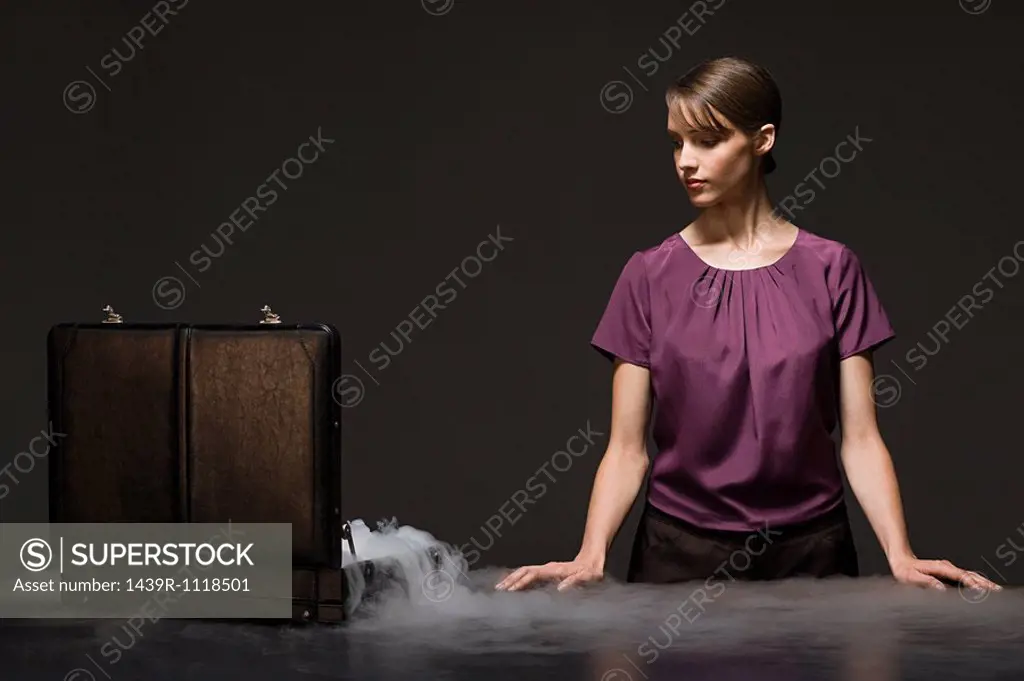 Woman with smoking briefcase