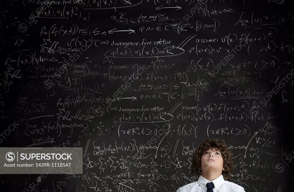 Boy in front of blackboard