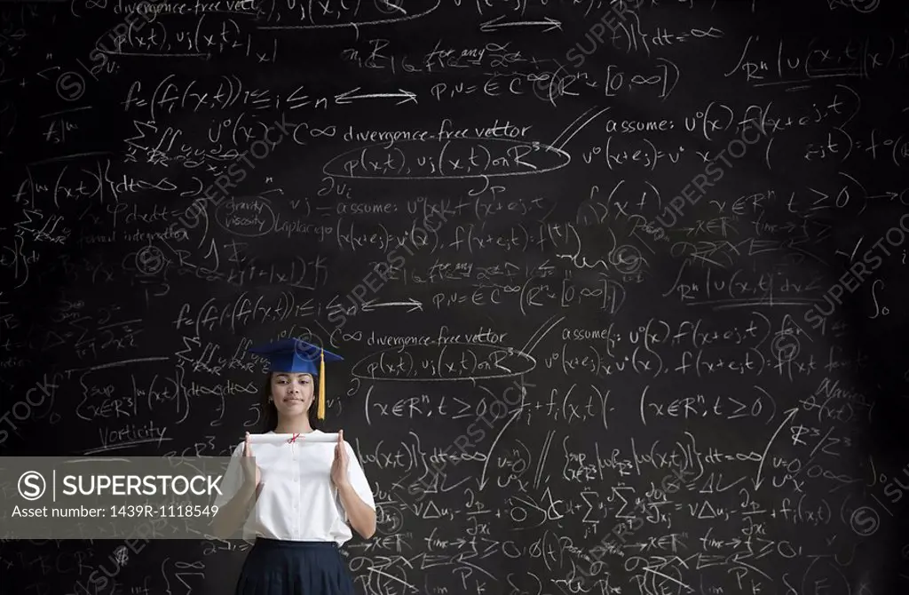 Graduating girl in front of blackboard