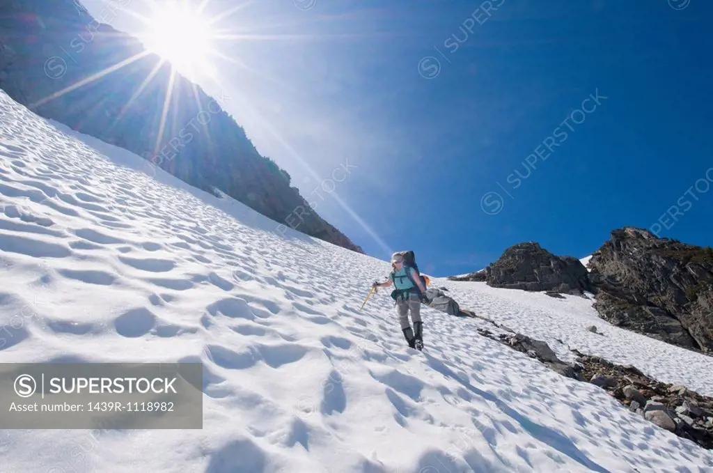 A female climber walking down a mountain