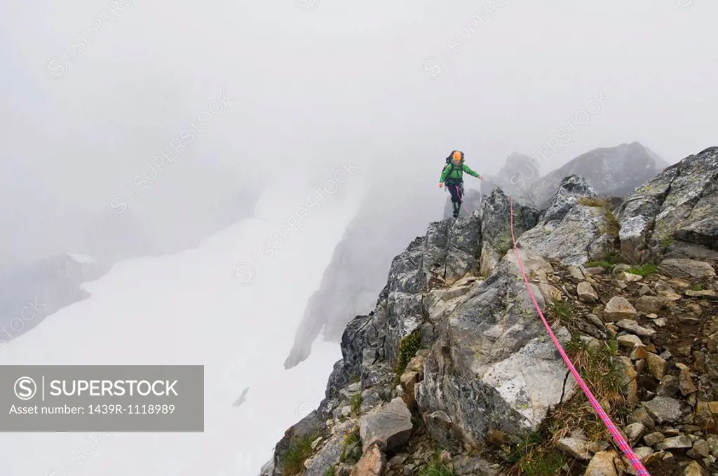 A woman climbing a mountain
