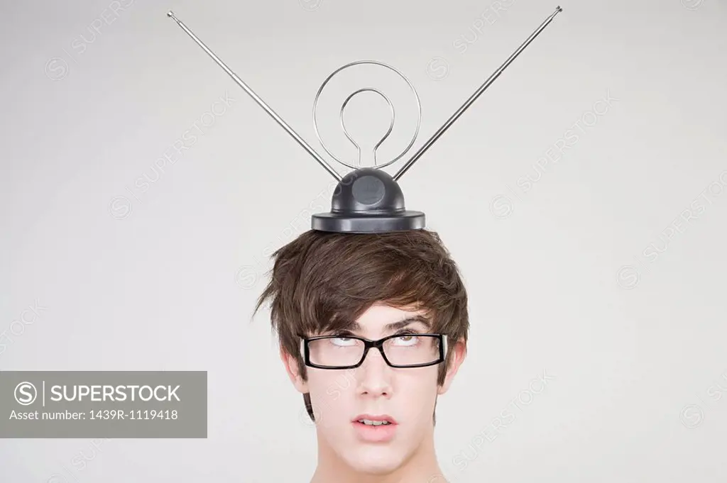 A teenage boy with an antenna on his head