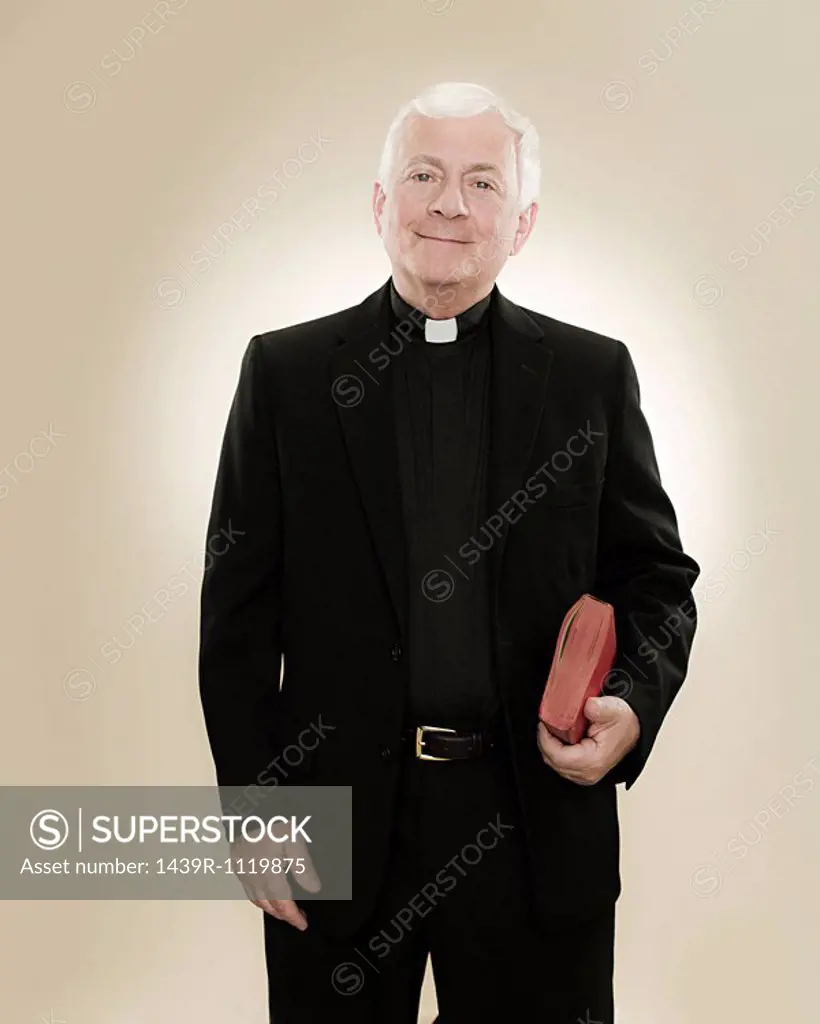 Portrait of a priest holding a bible