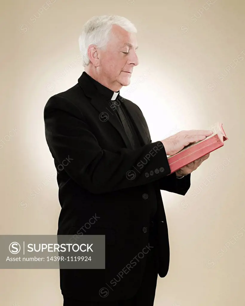A priest reading a bible