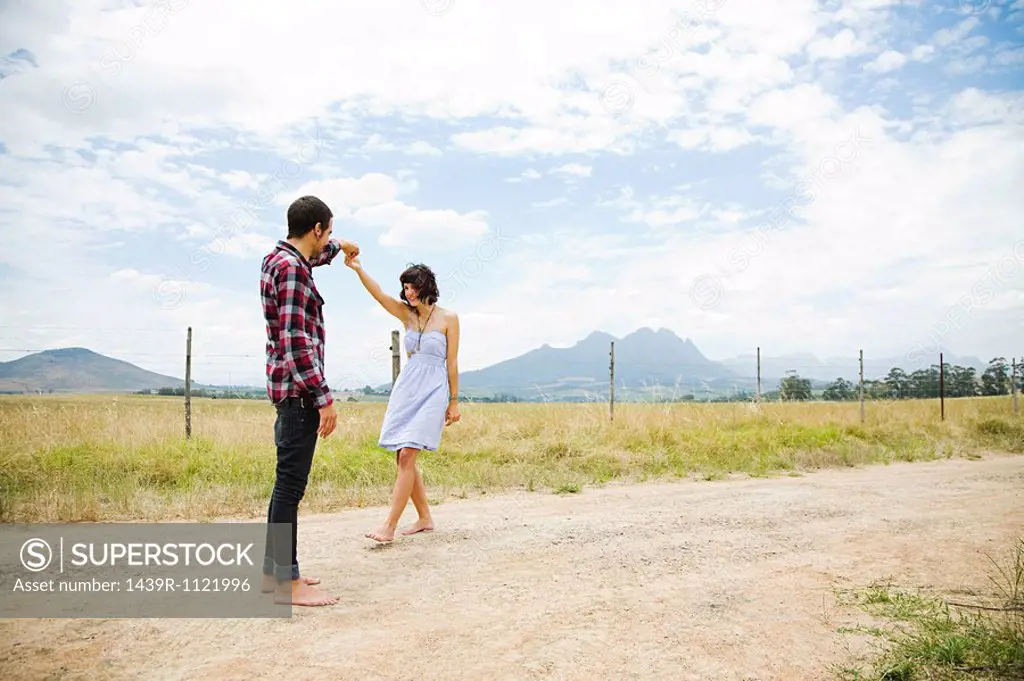 Young couple dancing in remote setting