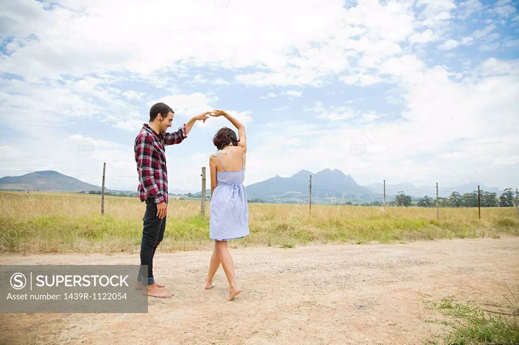 Couple dancing in a field
