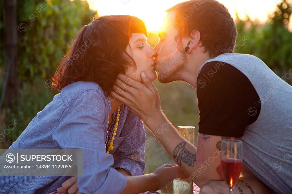 Couple kissing at sunset