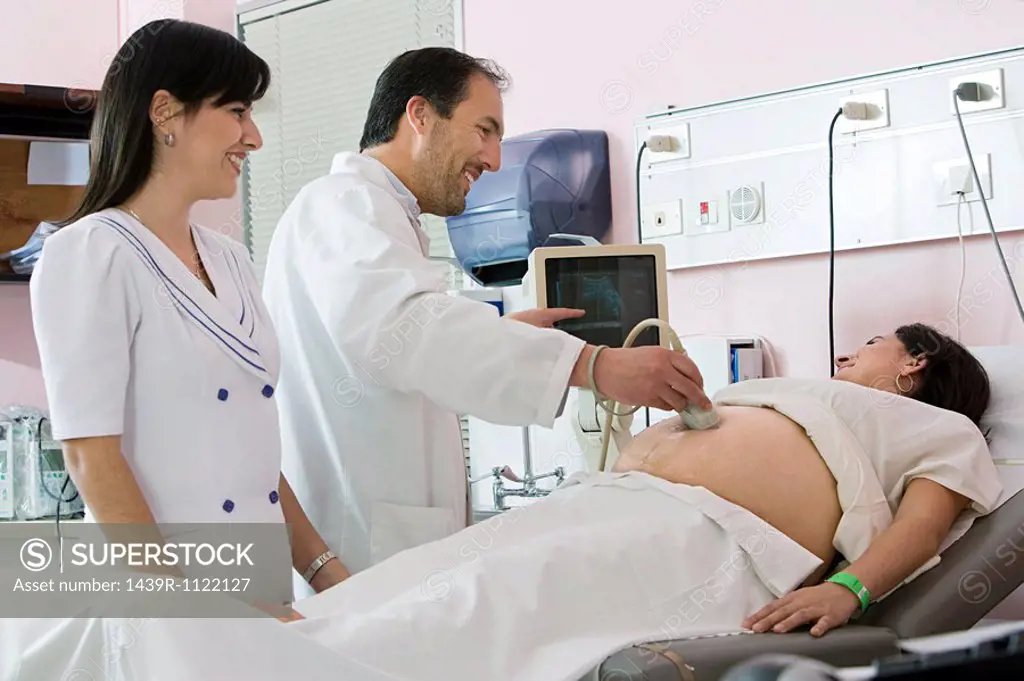 Pregnant woman having ultrasound scan