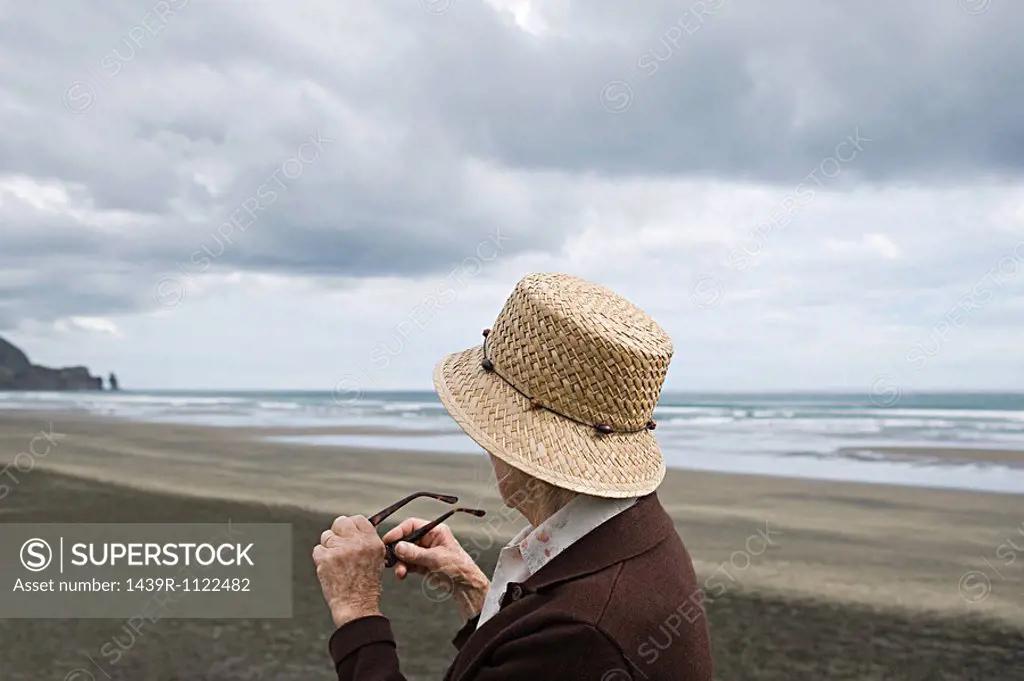 Senior woman on Piha Beach, Auckland