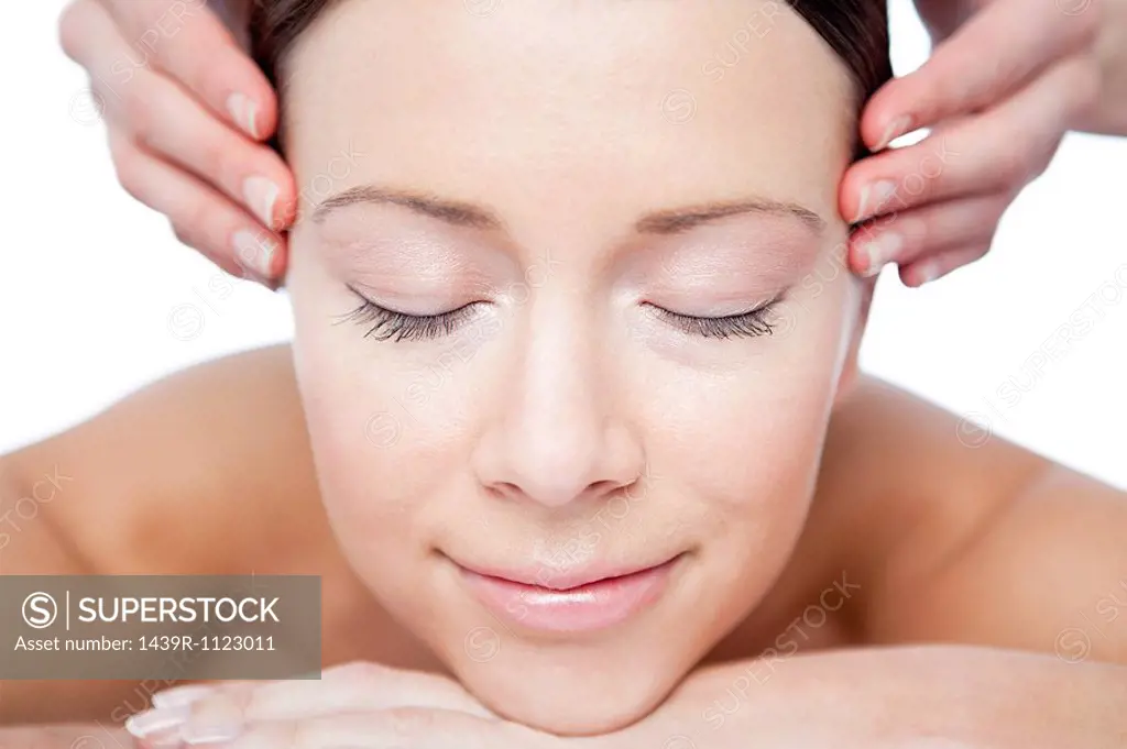 Woman having face massage