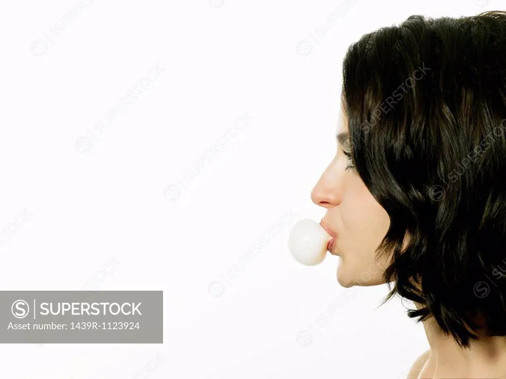 Young woman blowing bubble with gum