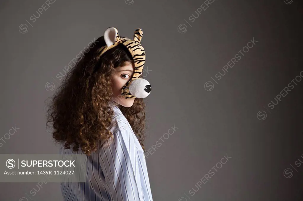 Young girl wearing tiger mask