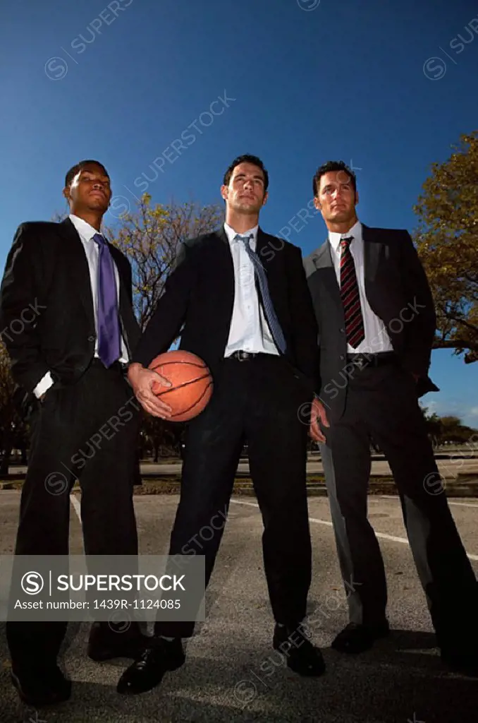 Businessmen on basketball court