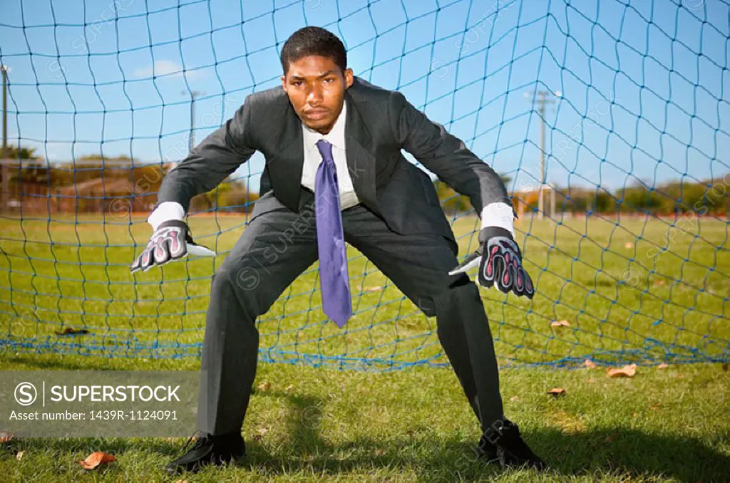 Businessman standing in goal