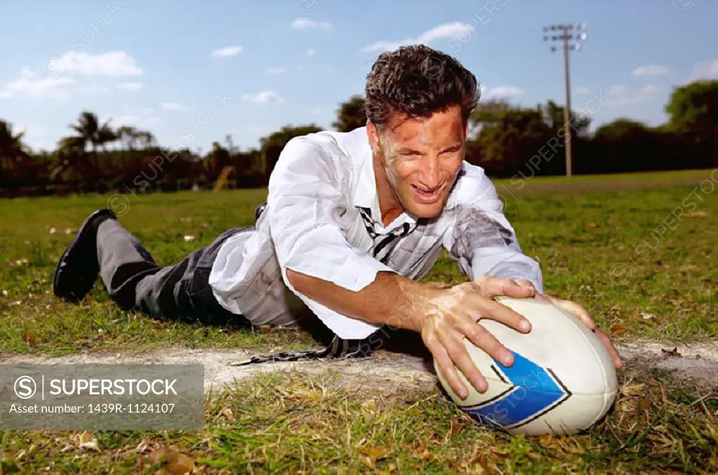 Businessman playing rugby
