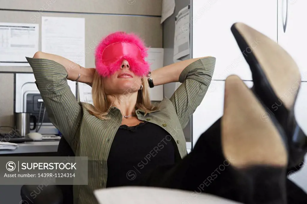 Woman wearing eyemask in the office