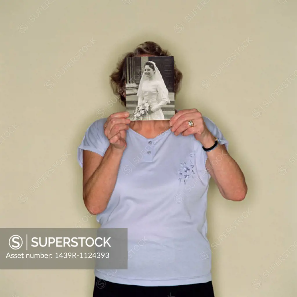Senior woman holding a photo of a bride