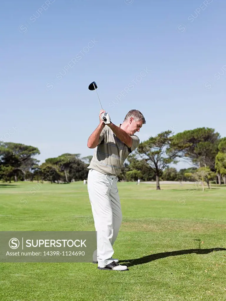Man playing golf on golf course