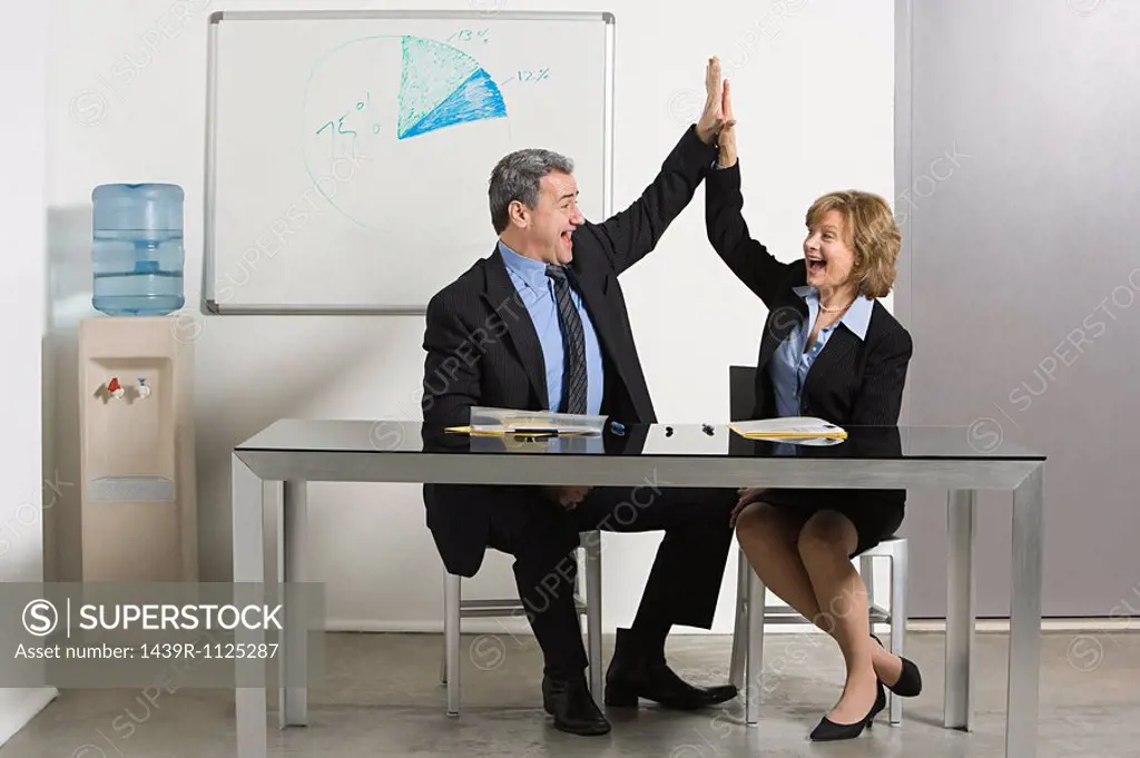 Businesspeople doing high five
