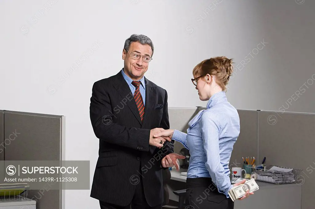 Businesswoman holding money behind her back