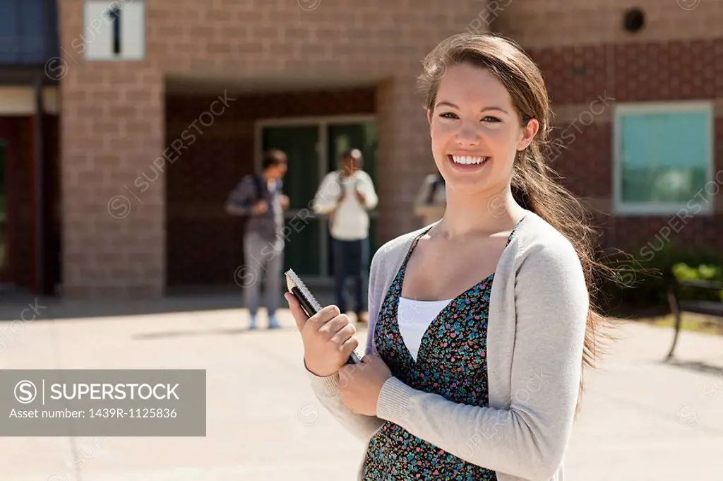 Female high school student outside school building