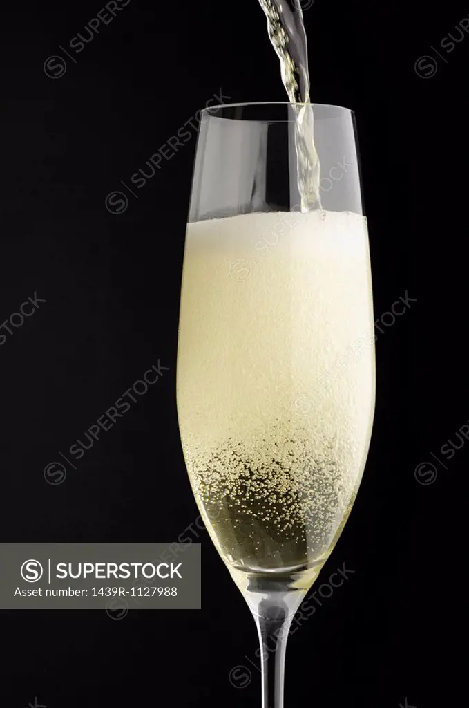 Champagne being poured into champagne glass