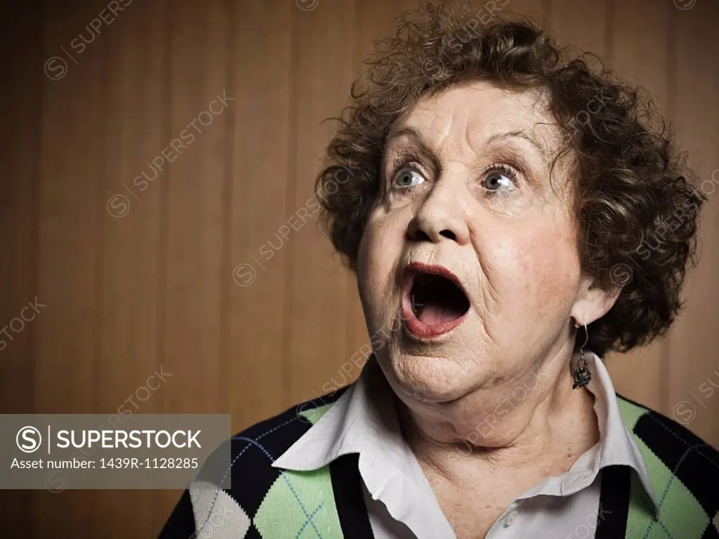 Studio portrait of shocked senior woman