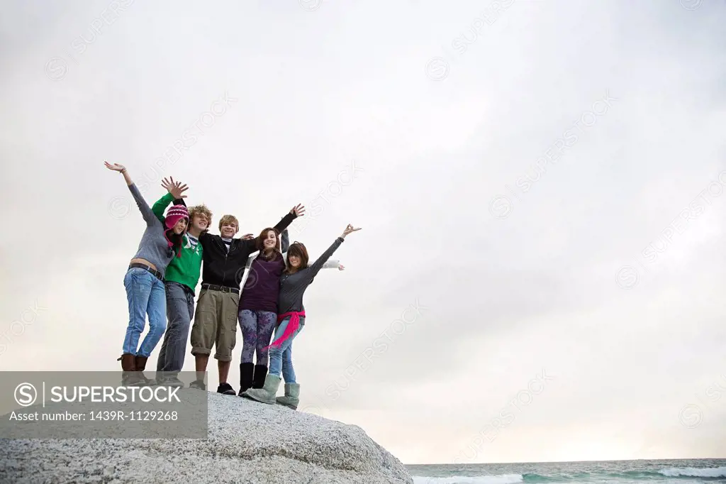 Group of friends standing on boulder