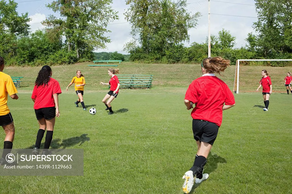 Teenage girls playing soccer