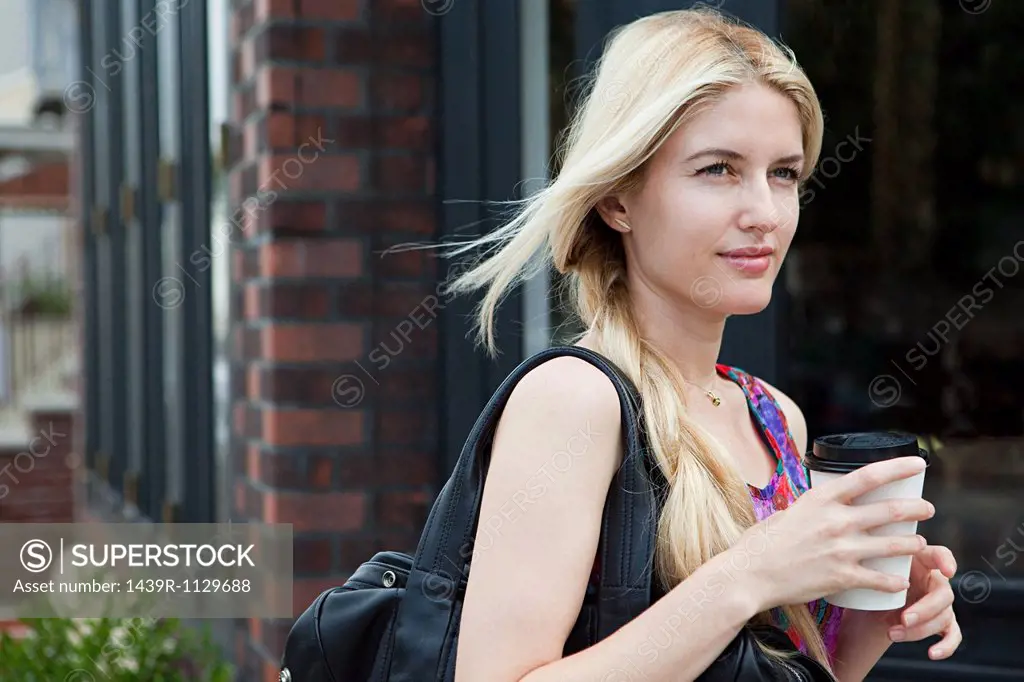 Woman with coffee to go