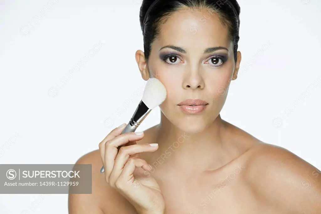 Woman with makeup brush