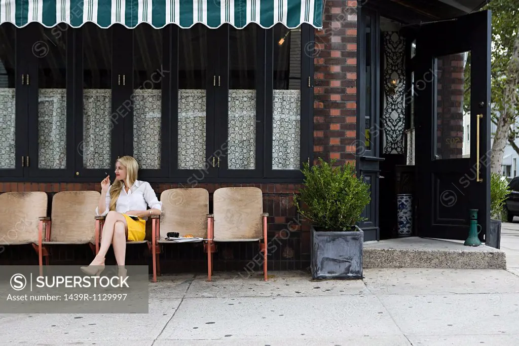 Woman sitting outside coffee shop
