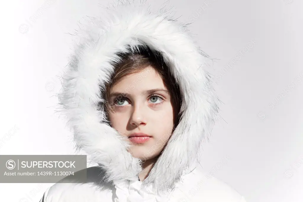 Girl wearing a white coat with fur hood