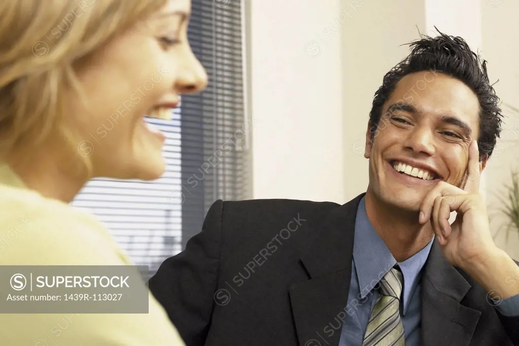 Businessman and businesswoman flirting