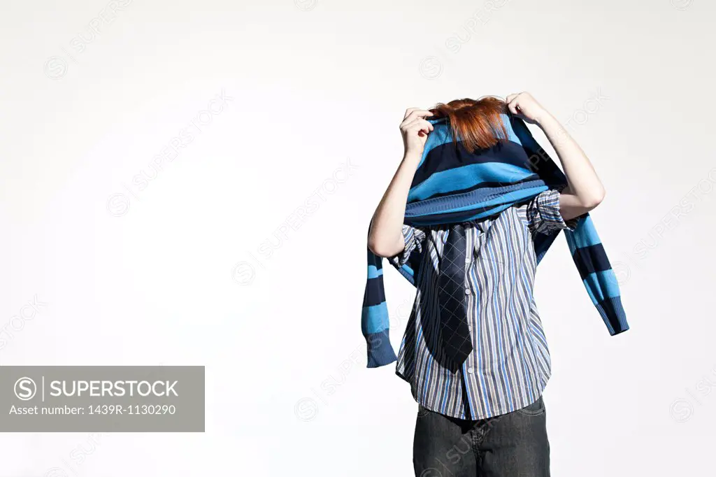 Boy taking off his sweater