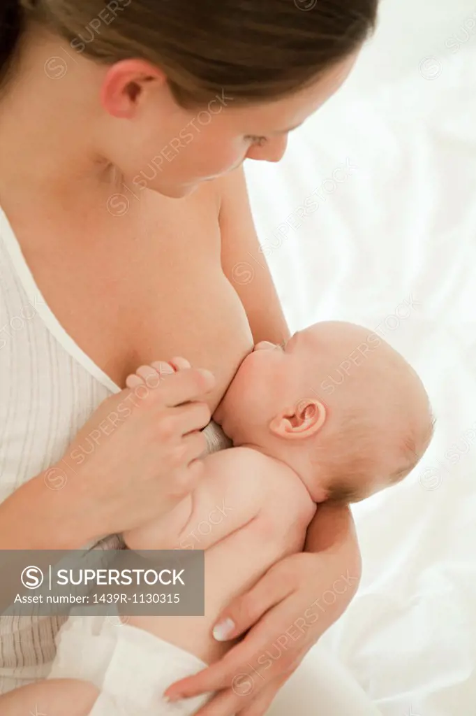 Mother breast feeding baby son