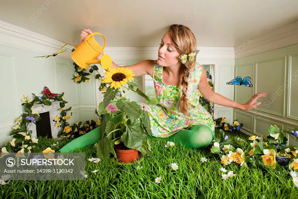 Young woman with garden in small room