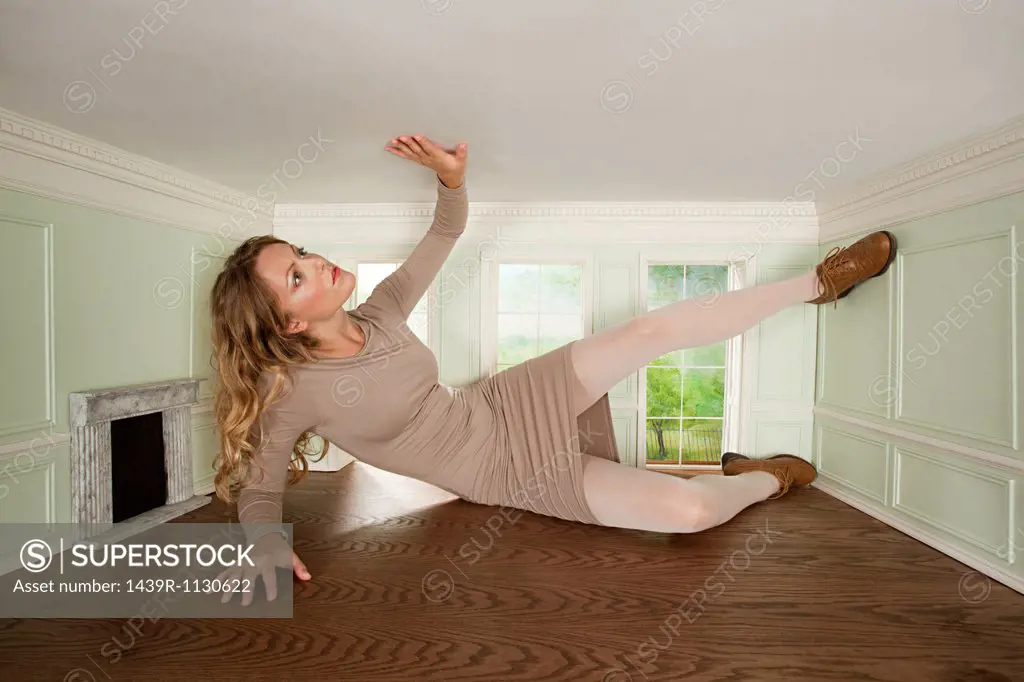 Giant young woman trapped in small room