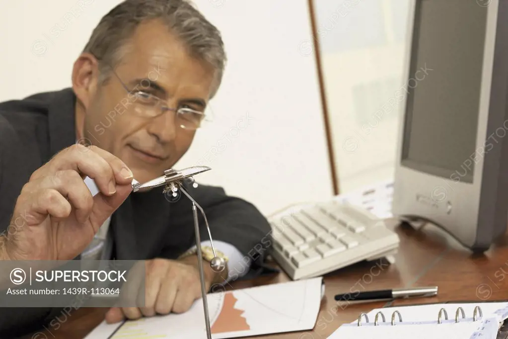 Businessman playing with executive toy