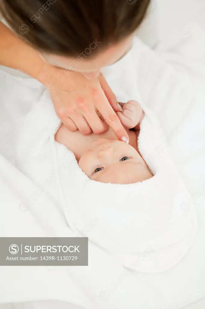 Mother and baby son wrapped in towel