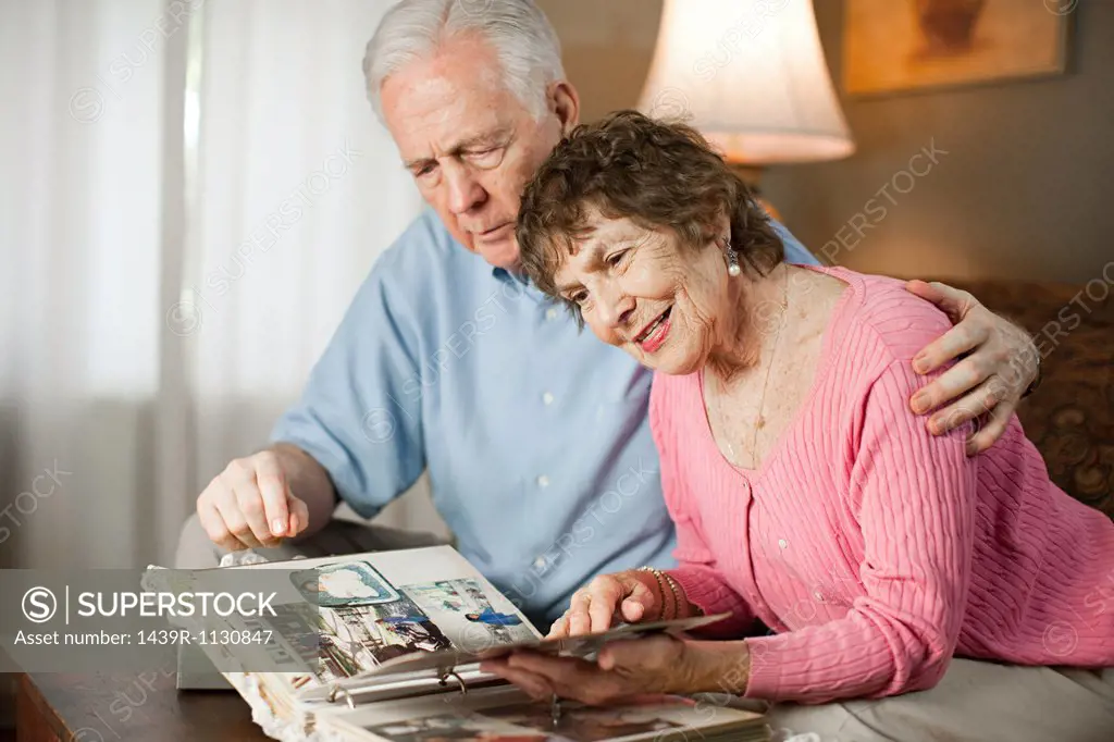 Senior couple looking at family album